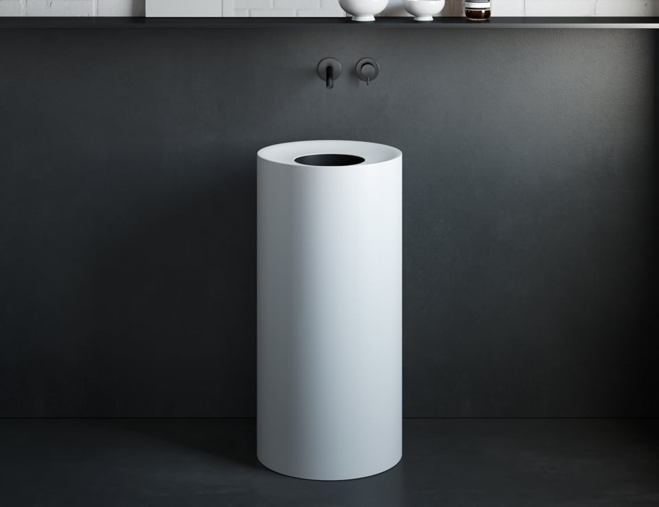 Freestanding resin washbasin in modern bathroom setting.