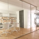 Glass and wood sliding partition door in an office setting
