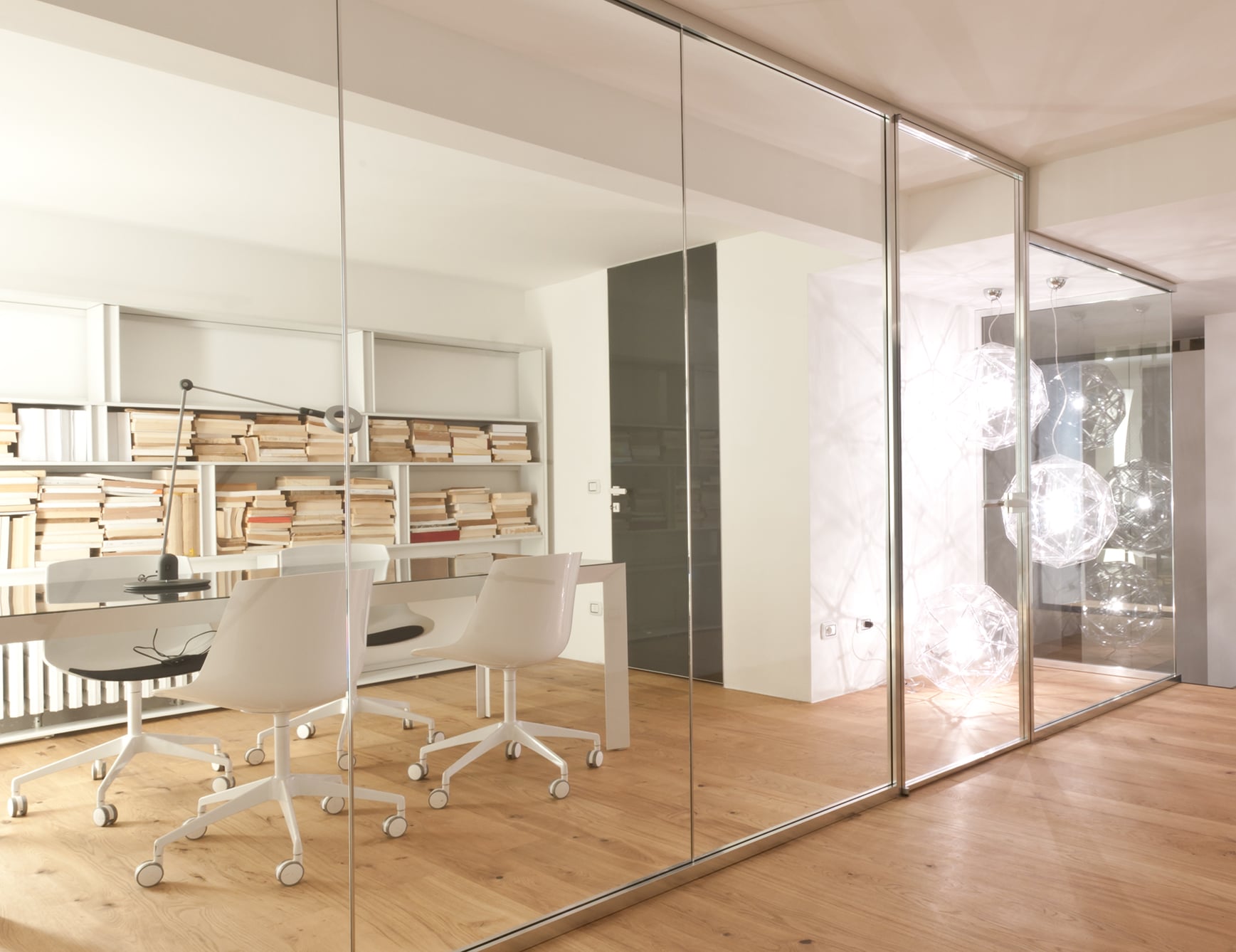 Glass and wood sliding partition door in an office setting