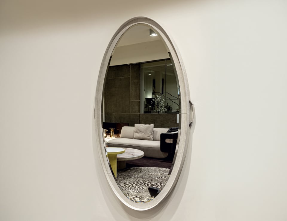 Elegant oval mirror on white wall