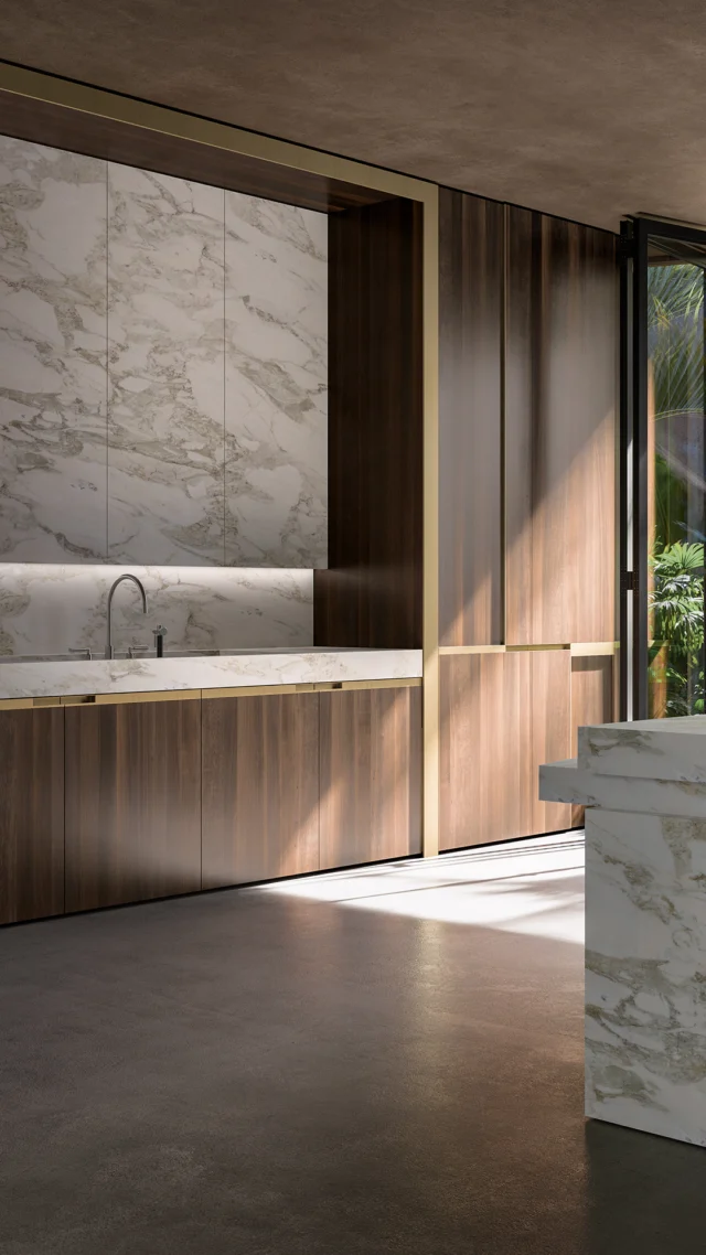 Introducing our CASA NV project, a collaboration between Studio NV and Nella Vetrina. This fully bespoke custom kitchen exemplifies our passion for meticulous craftsmanship and attention to detail, featuring floor-to-ceiling custom pocket doors in Noce Canaletto walnut with inlaid bronze metal trim and integrated handles. The upper cabinet doors are book-matched in Calacatta Gold marble to create a striking central feature wall while providing storage and functionality. The kitchen island is a sculptural work of art, created from a single block of white Calacatta Gold marble with integrated brass handles. Each piece is hand-crafted with precision in Italy.