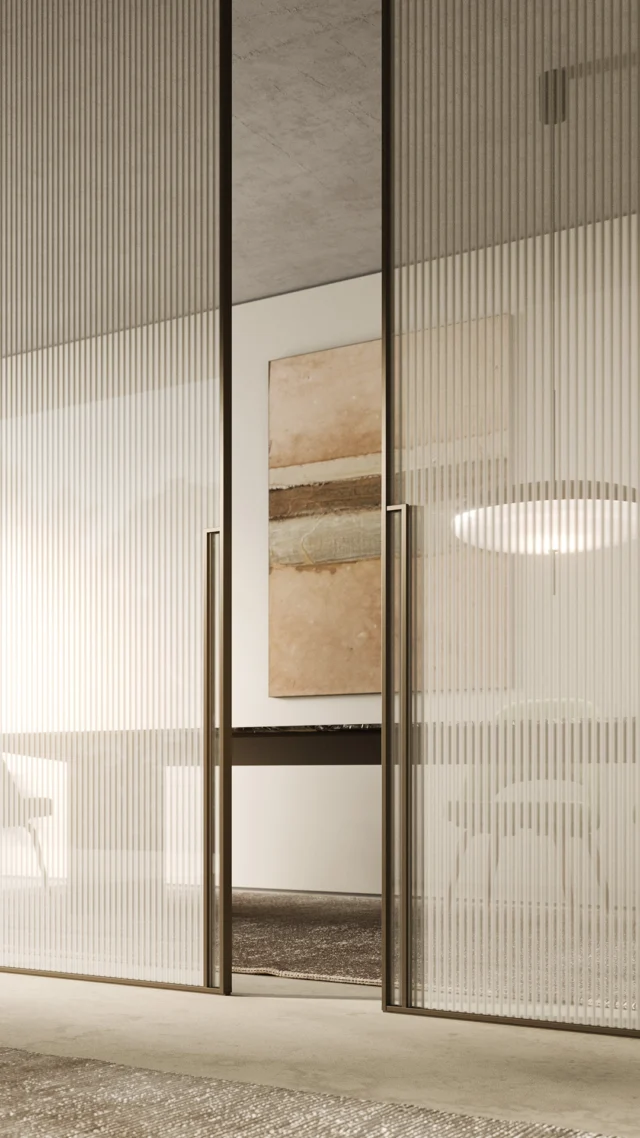Introducing the Manhattan sliding door system from Italy, featuring bronze glass with a channelled Canneté pattern and framed in Moka finish with Square handles. Metal finish options include black, white, aluminum, titanium, moka, and brass. The Canneté pattern can be completely customized and is characterized by irregularly spaced vertical lines, utilizing the interplay of glass and light to create elegant visual movement. The Manhattan collection offers adaptability for sophisticated atmospheres in living and bedroom areas, available as a 180-door, swing door, disappearing sliding door, outside sliding door, or wall system. Finishes and profiles can be customized upon request.
#nellavetrina #livingroomdesign #livingroomdecoration #livingroominspiration #luxurylivingroom #livingroomgoals #italianfurniture #customfurniture #italiandesign #interiordesign #decoration #interiordecor #modernfurniture #customdesign #contemporaryfurniture #homedecor #italianinterior #custommade #architecture #interiordesigner #luxuryfurniture #luxuryliving #italianliving #luxurydesigns